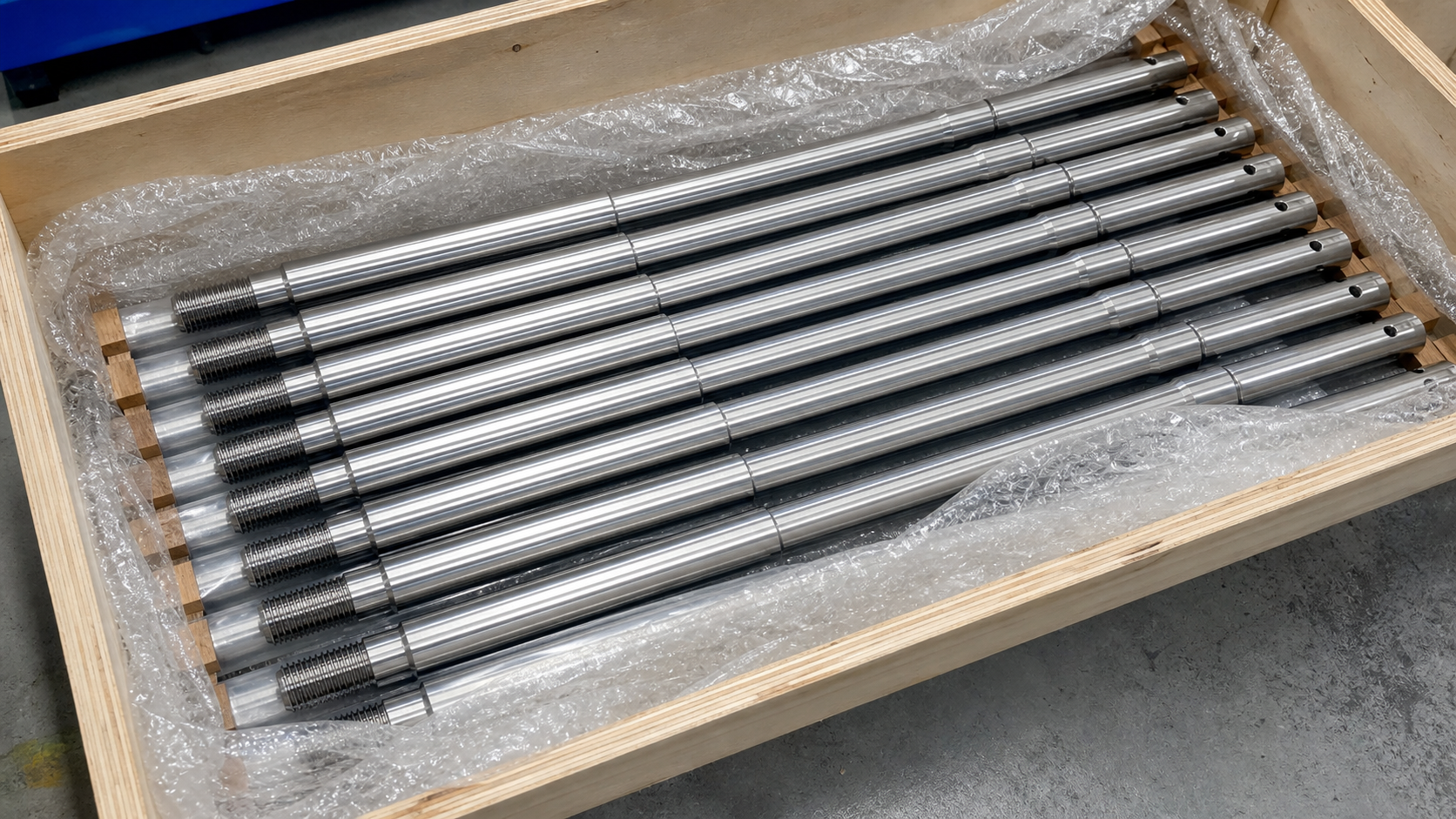 Representative long CNC turned shafts prepared with protective packing